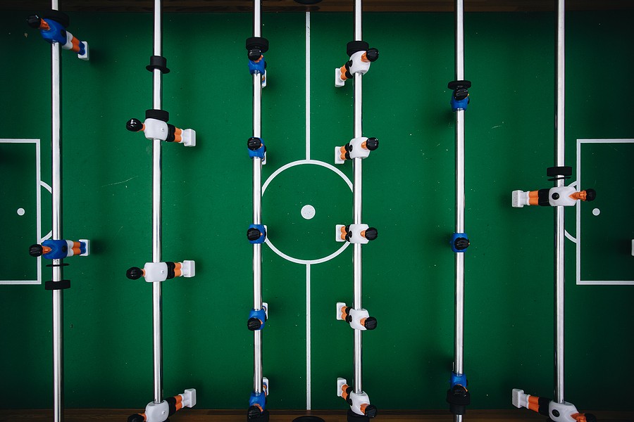 Table Football with White and Blue Players from Above