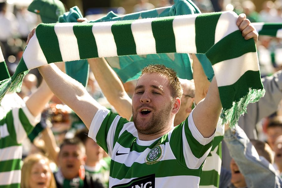 Celtic supporter holding up scarf